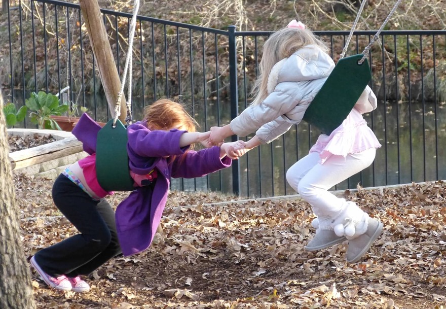 Emily and Anna Kate on the swings and Mrs. Paula's Preschool